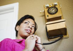Woman on antique telephone