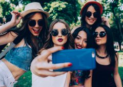 five beautiful young girls make selfie in the park